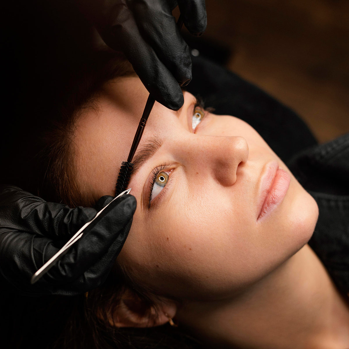 high-angle-female-clinician-doing-eyebrow-treatment-female-customer.jpg__PID:04b0ff86-9cb4-4adf-8472-138fcb195ecc